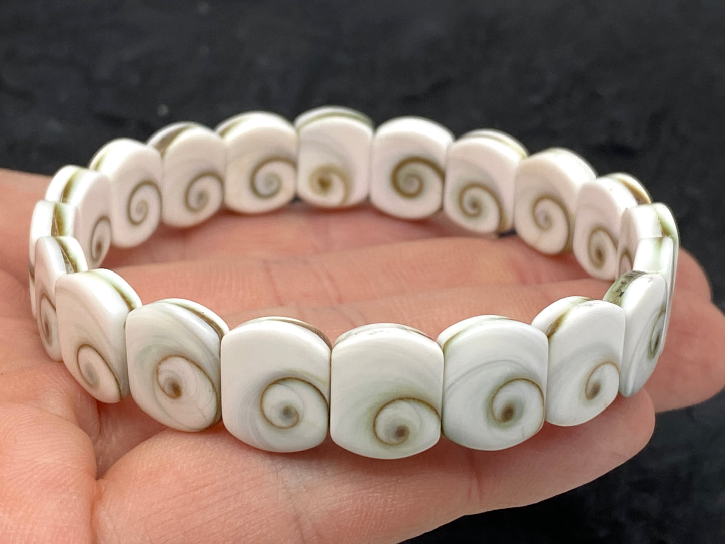 Shiva Eye Shell Beads Bracelet From Pacific Ocean (AAA Whitest White Quality - Every Bead Made From Two Operculum Shells - Matching Spiral Matrix) Men Jewelry Durable Double-Drilled 10X12mm Elastic 7.25 Inches (Protective Door of the Snail Shell)